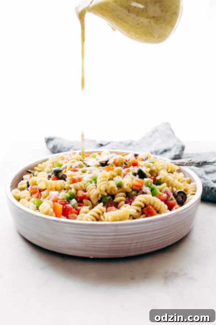 California Pasta Salad - made with homemade roasted garlic Italian dressing and tons of yummy salad toppings! Perfect for potlucks or picnics! #pastasalad #californiasalad #salad #spaghettisalad #potluck #choppedsalad | Littlespicejar.com Ingredients for California Pasta Salad laid out before mixing, emphasizing freshness and simplicity.