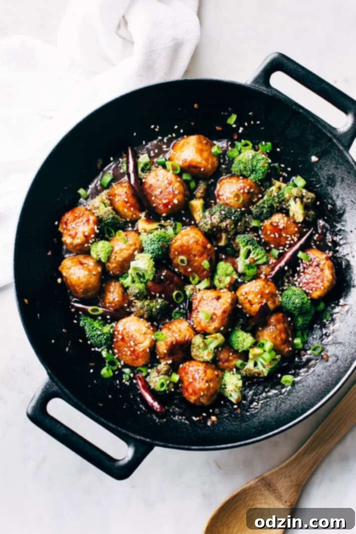 Platter of homemade General Tso's Chicken Meatballs served with steamed broccoli and jasmine rice.