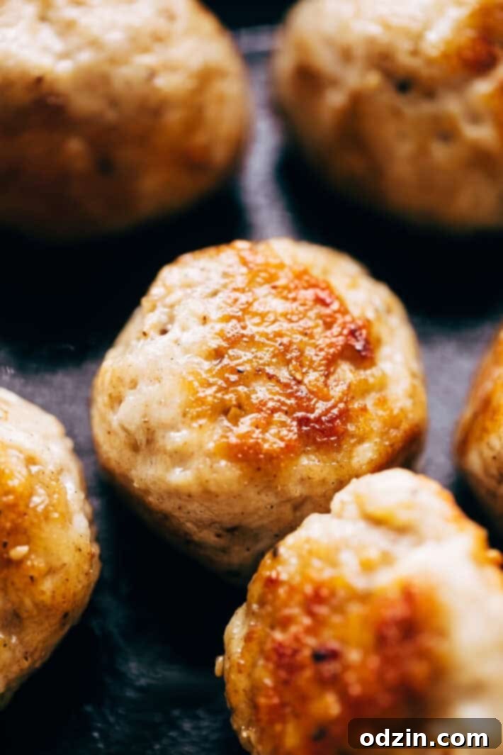 General Tso's Chicken Meatballs served with rice and garnished with green onions.