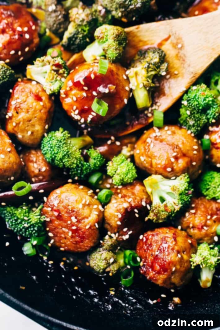 A bowl of General Tso's sauce with meatballs and broccoli.