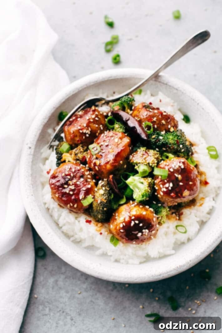 General Tso's Chicken Meatballs in a serving bowl with rice.