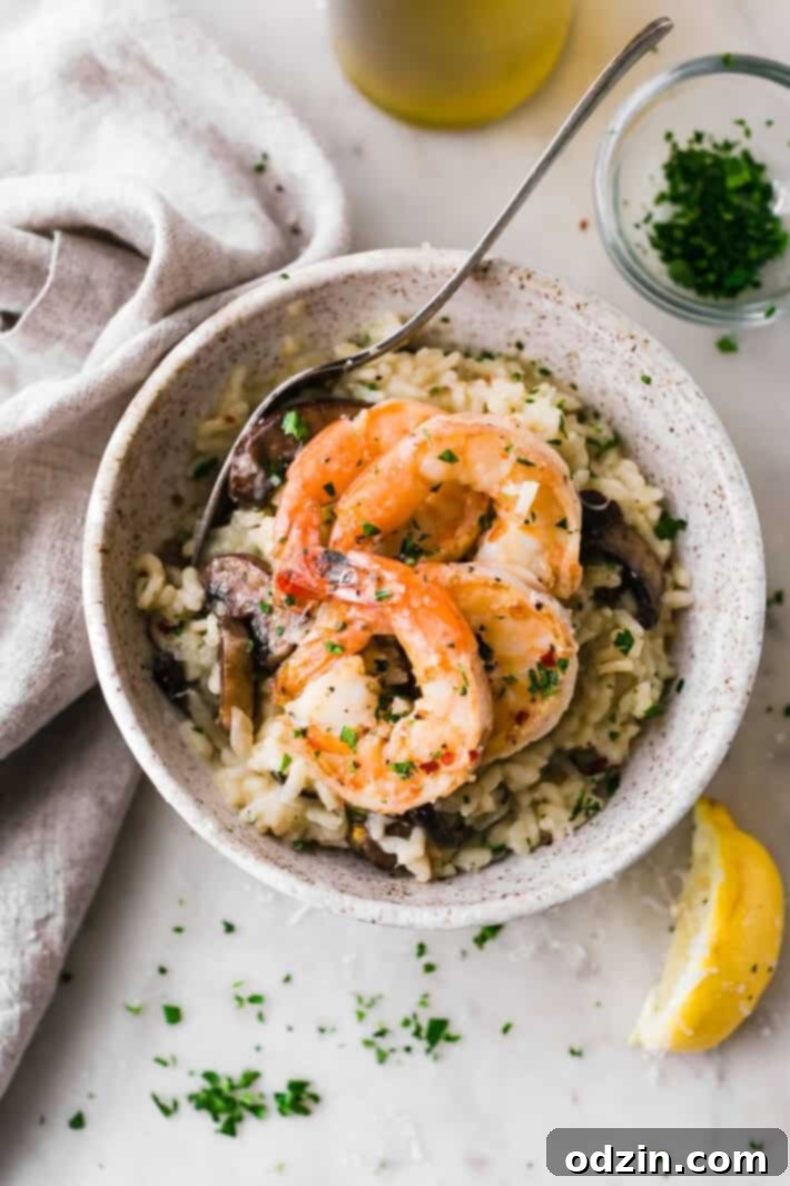 Mushroom Parmesan Shrimp Risotto - Learn how to make shrimp risotto at home with ease! Loaded with sautéed mushrooms, shrimp and tons of garlic! #shrimprisotto #mushroomrisotto #parmesanrisotto #homemaderisotto | Littlespicejar.com