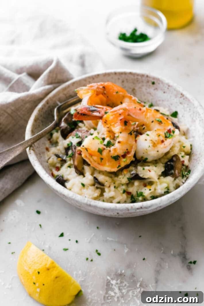 Mushroom Parmesan Shrimp Risotto - Learn how to make shrimp risotto at home with ease! Loaded with sautéed mushrooms, shrimp and tons of garlic! #shrimprisotto #mushroomrisotto #parmesanrisotto #homemaderisotto | Littlespicejar.com