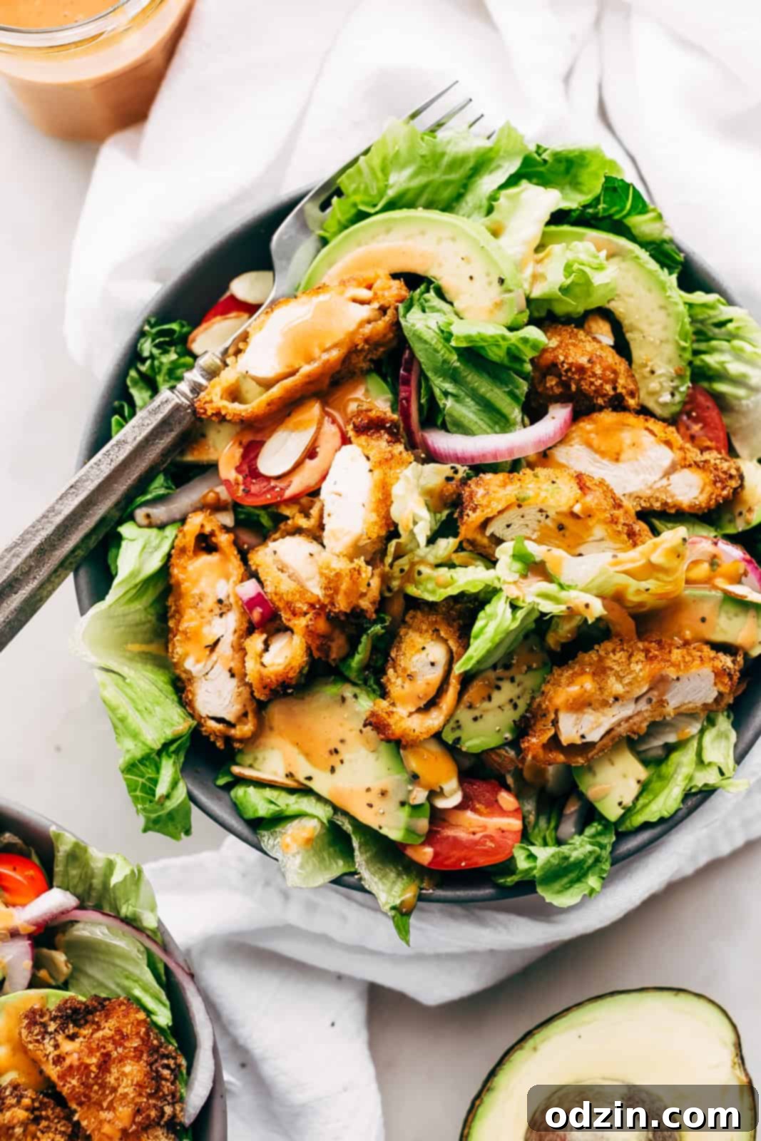 plate with strips of crispy chicken on a bed of salad