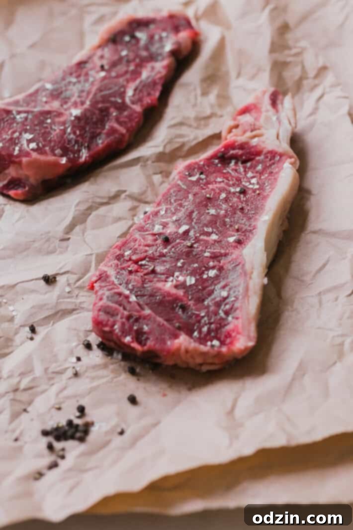 Ingredients for homemade garlic herb butter, including fresh herbs, pressed garlic, and softened butter, in a small bowl.