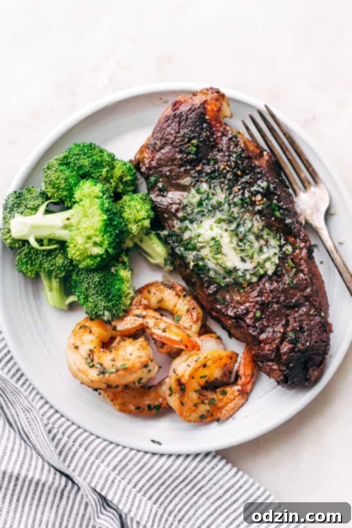 A perfectly cooked medium-rare steak being sliced, showing a juicy pink center, ready to be topped with garlic butter.