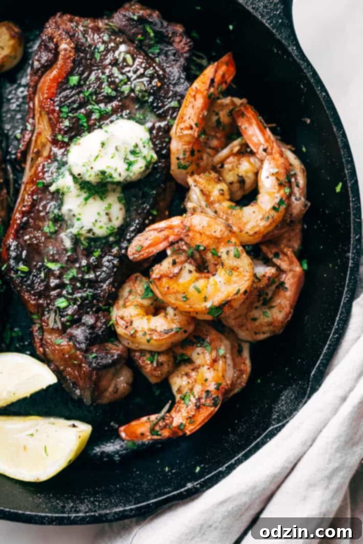 Juicy pan-seared shrimp sizzling in fragrant garlic butter in a hot cast iron skillet, garnished with fresh herbs.
