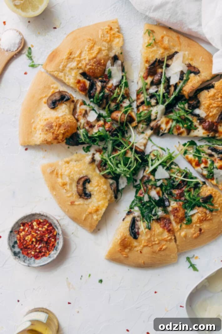 A final shot of the Homemade Truffled Mushroom Pizza with Arugula Salad, showcasing its gourmet appeal, delicious toppings, and golden crust, ready for a delightful meal.