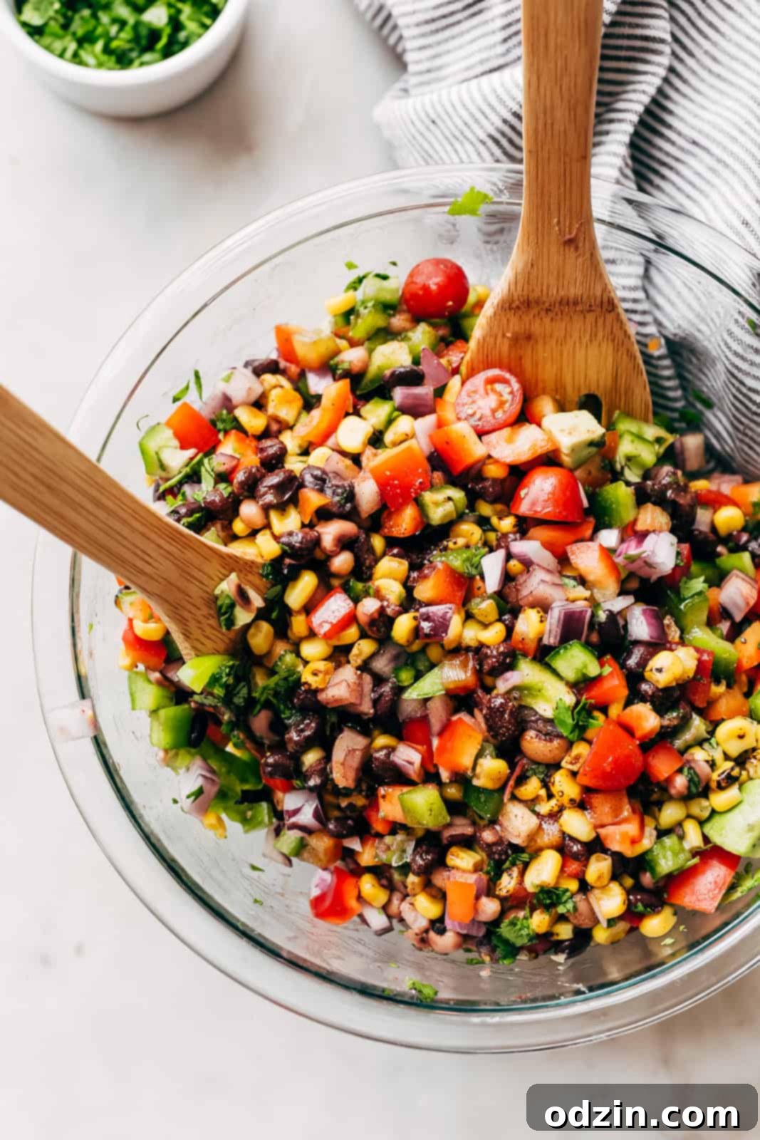 combining ingredients in a bowl with wooden utensils