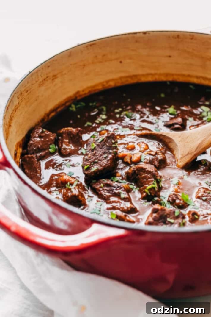 prepared Texas chili recipe in red cast iron pot 