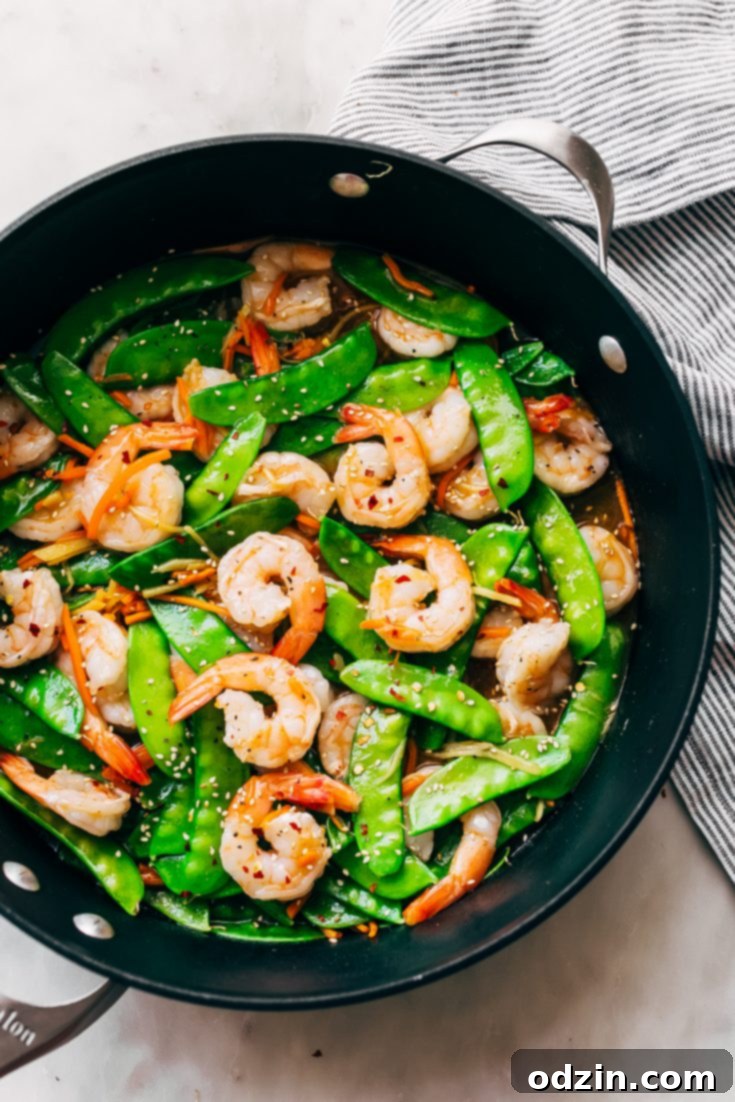 10-Minute Ginger Shrimp Snow Pea Stir Fry, served with rice