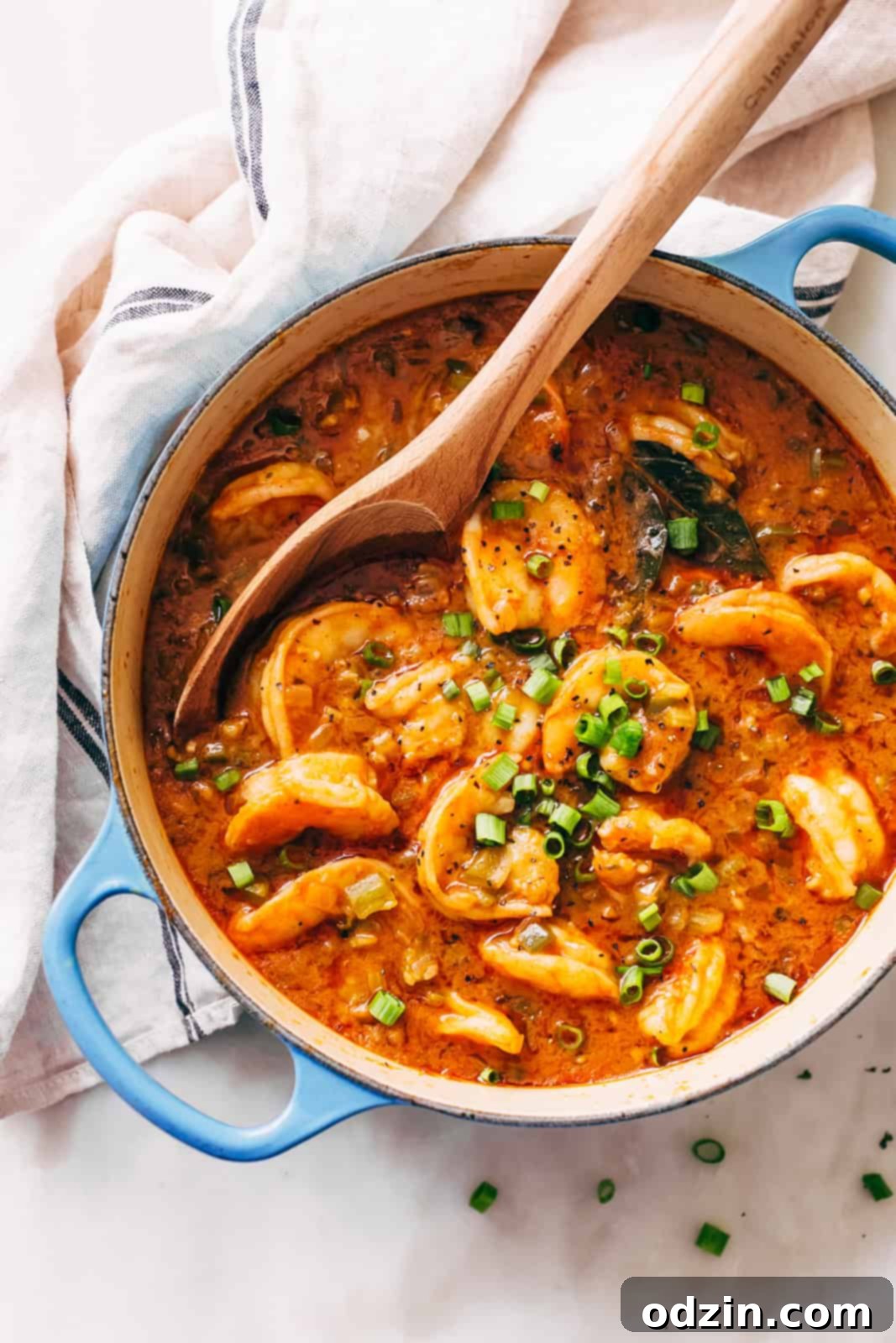 Spicy Cajun Shrimp Etouffee 7 prepared étouffée with wooden spoon in blue cast iron pot