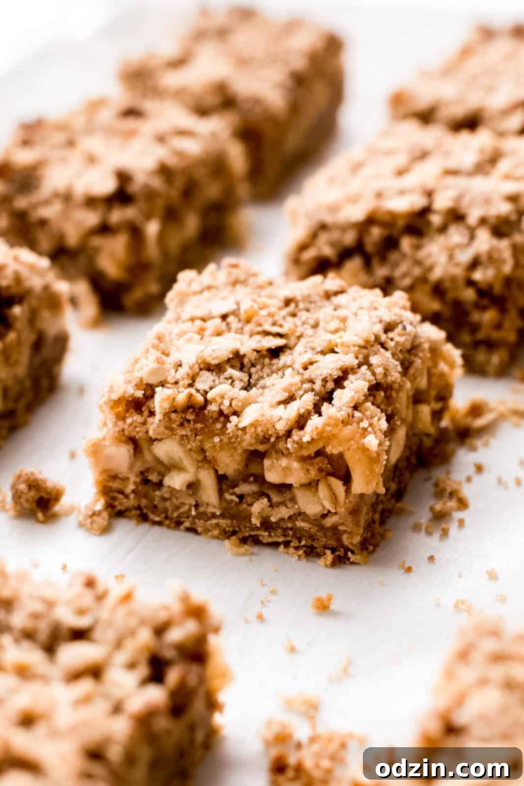 Golden Apple Crumble Bars 3 separated out apple crumble bars on parchment