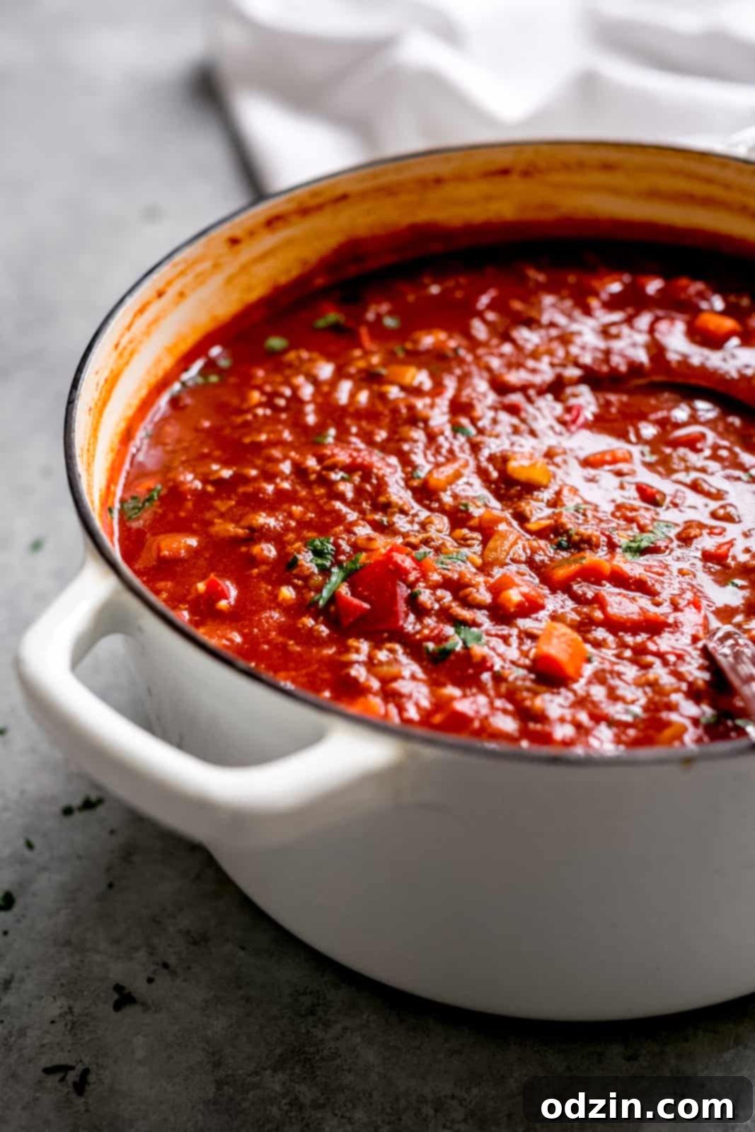 stuffed pepper soup in white cast iron soup pot on grey surface