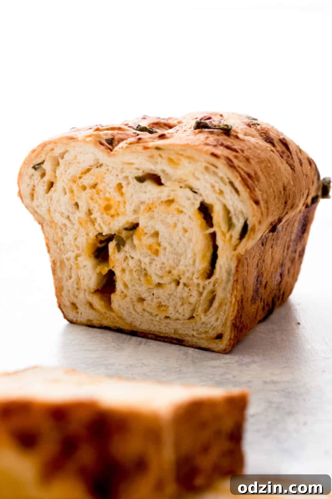 Spicy Cheddar Jalapeño Loaf 12 slice loaf to show inside texture of bread with swirled cheese and jalapeños