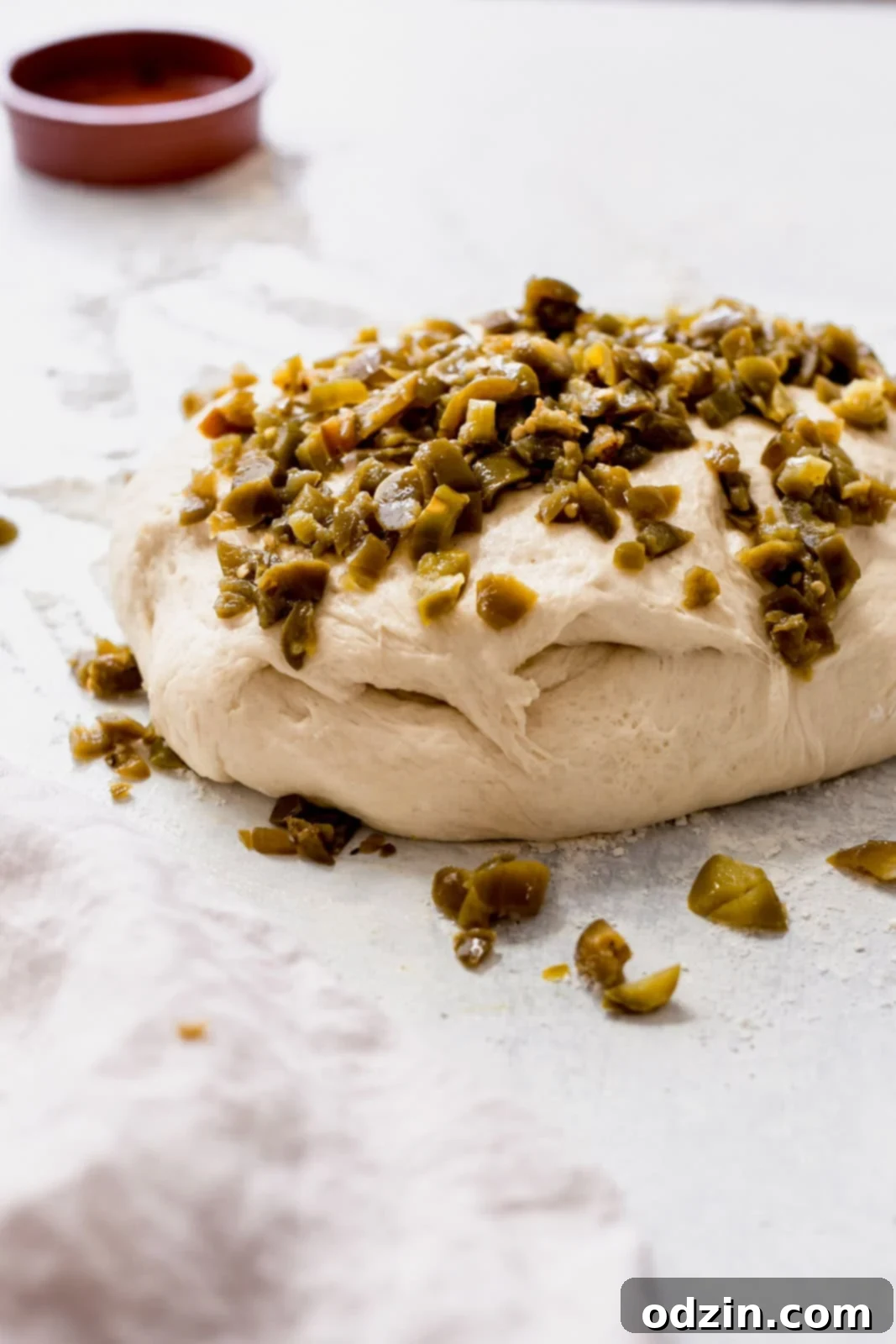 Spicy Cheddar Jalapeño Loaf 6 bread dough with minced pickled jalapeños on top