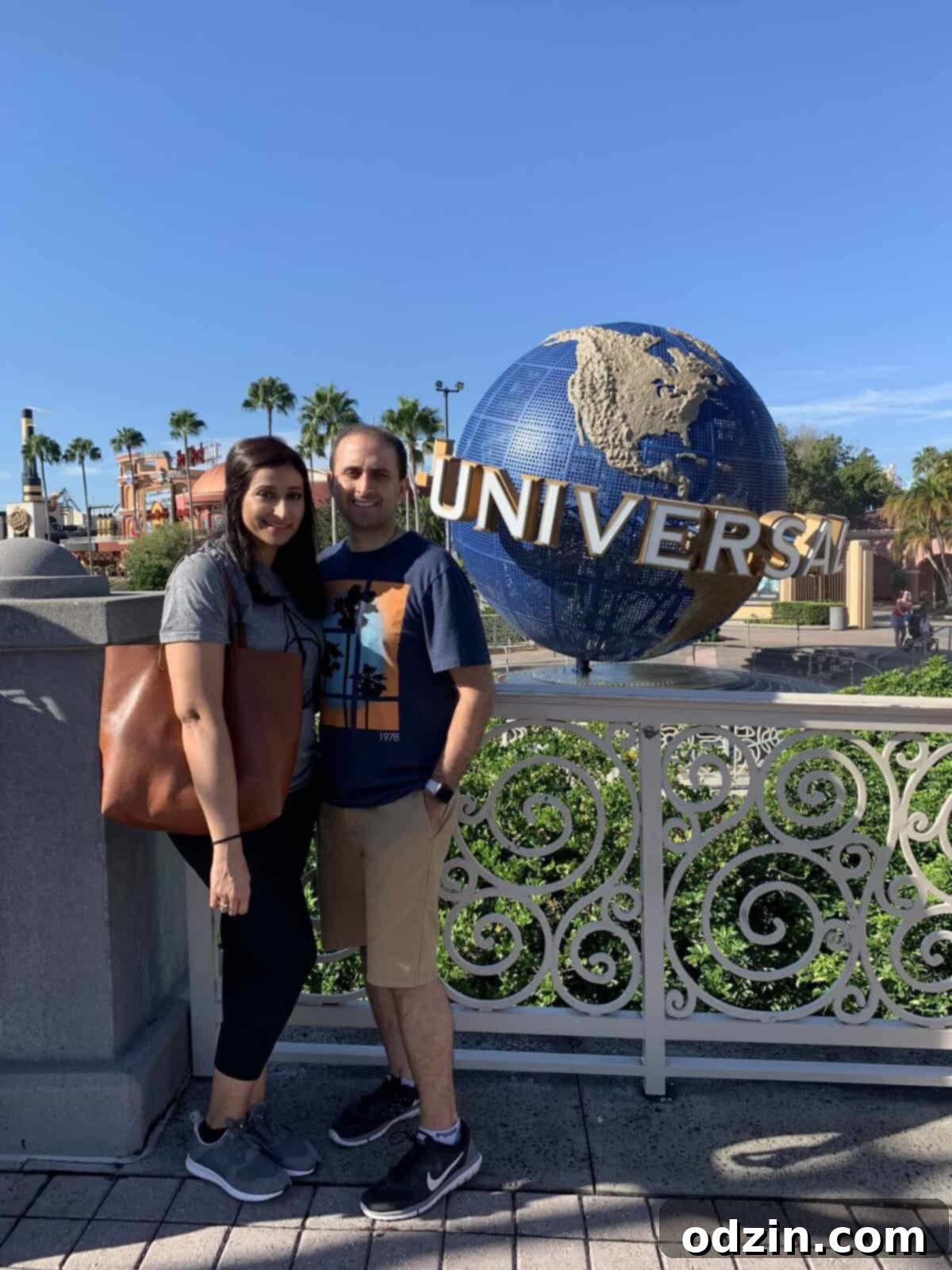 My husband and I posing at Universal Studios, with my stylish leather tote bag visible.