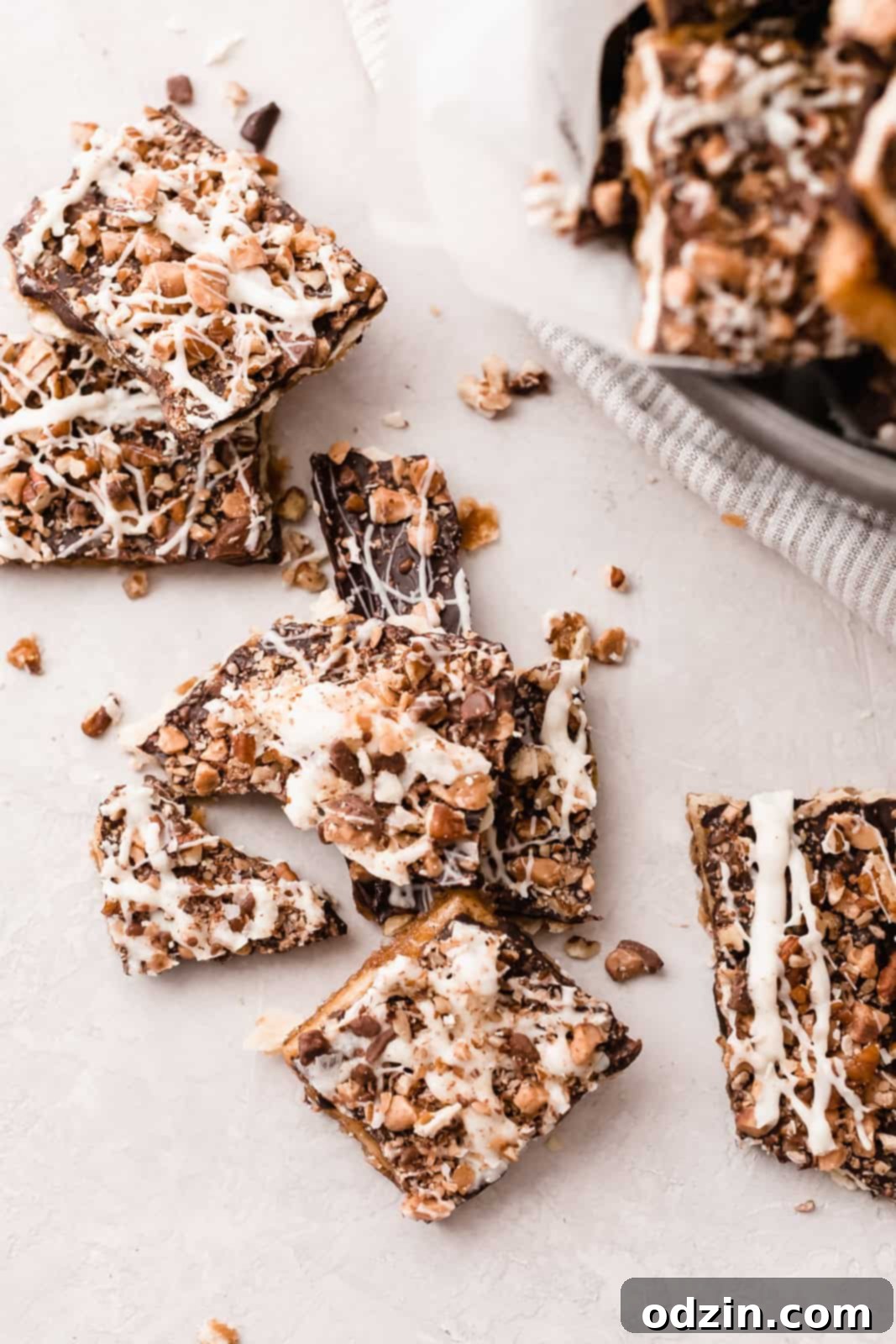 pieces of Christmas crack with broken bits on grey surface with striped towel and bucket
