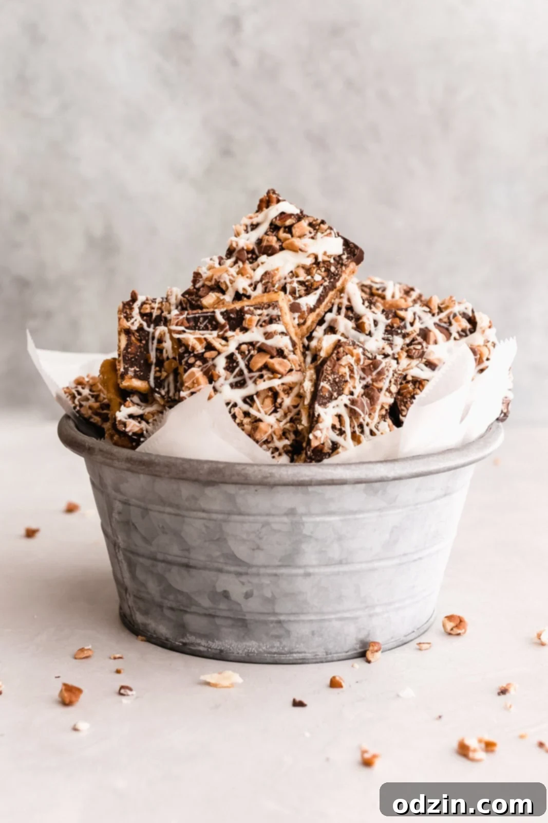 galvanized bucket lined with wax paper filled with pieces of Christmas crack
