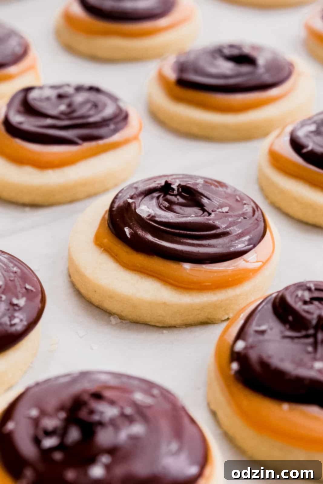 Copycat Twix Shortbread Cookies 3 close up of shortbread cookies drying on parchment lined sheet pan