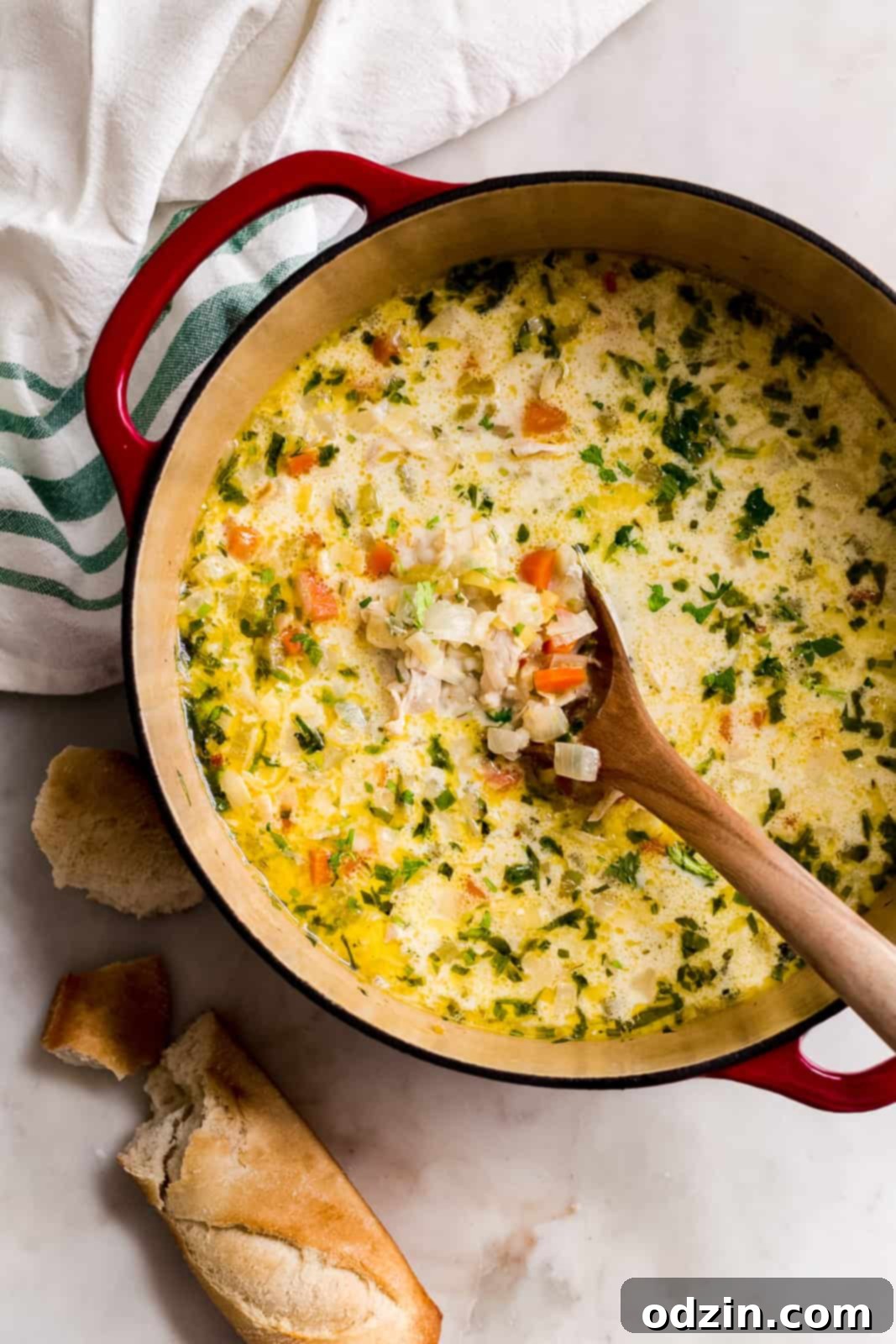 Sunshine Lemon Chicken Barley Soup 4 cast iron pot filled with prepared soup and a wooden spoon