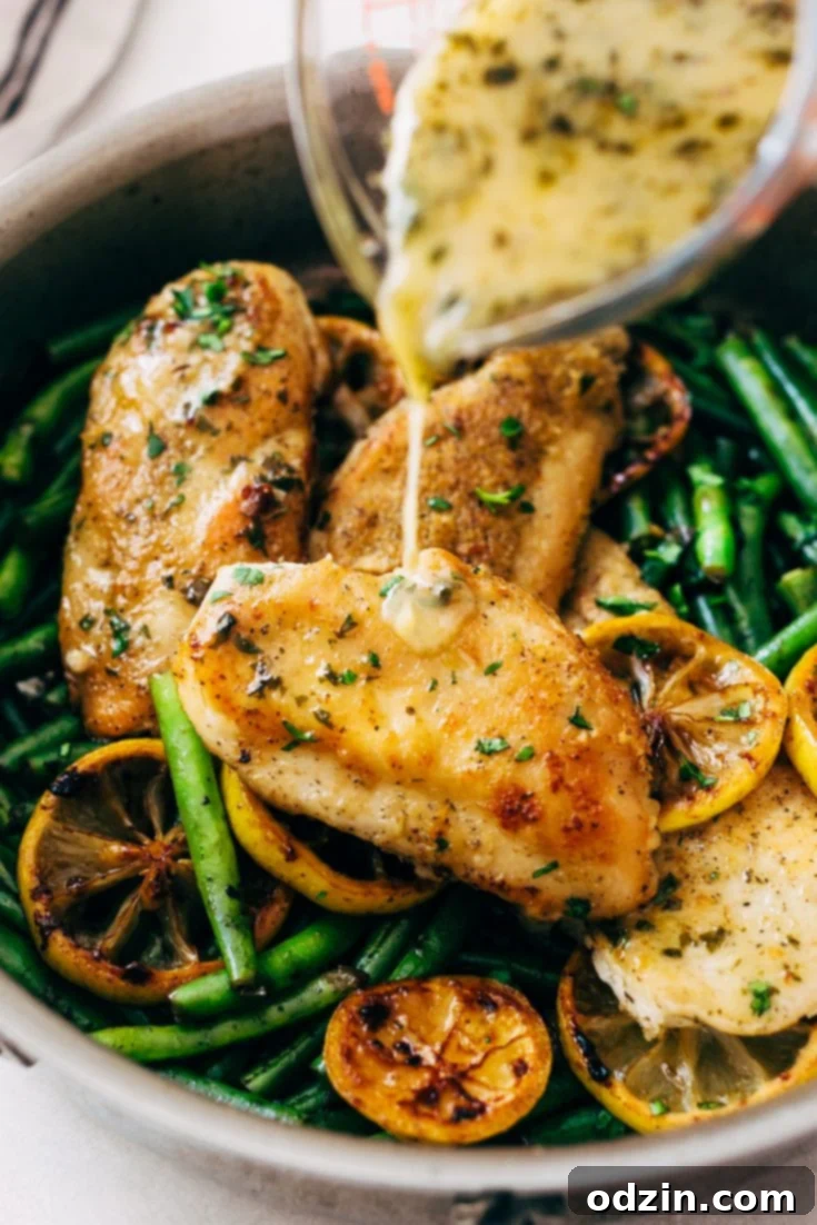 Skillet Garlic Lemon Butter Chicken, showing a serving on a plate with greens