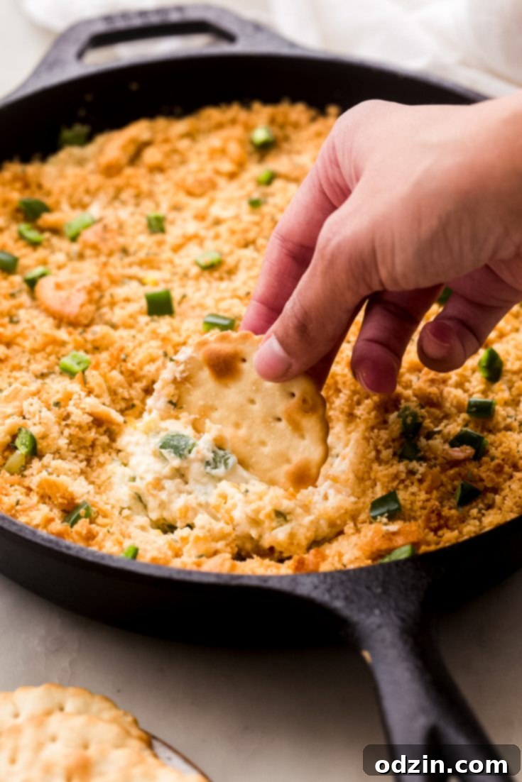 Addicting Jalapeño Popper Dip with cracker topping, perfect for parties