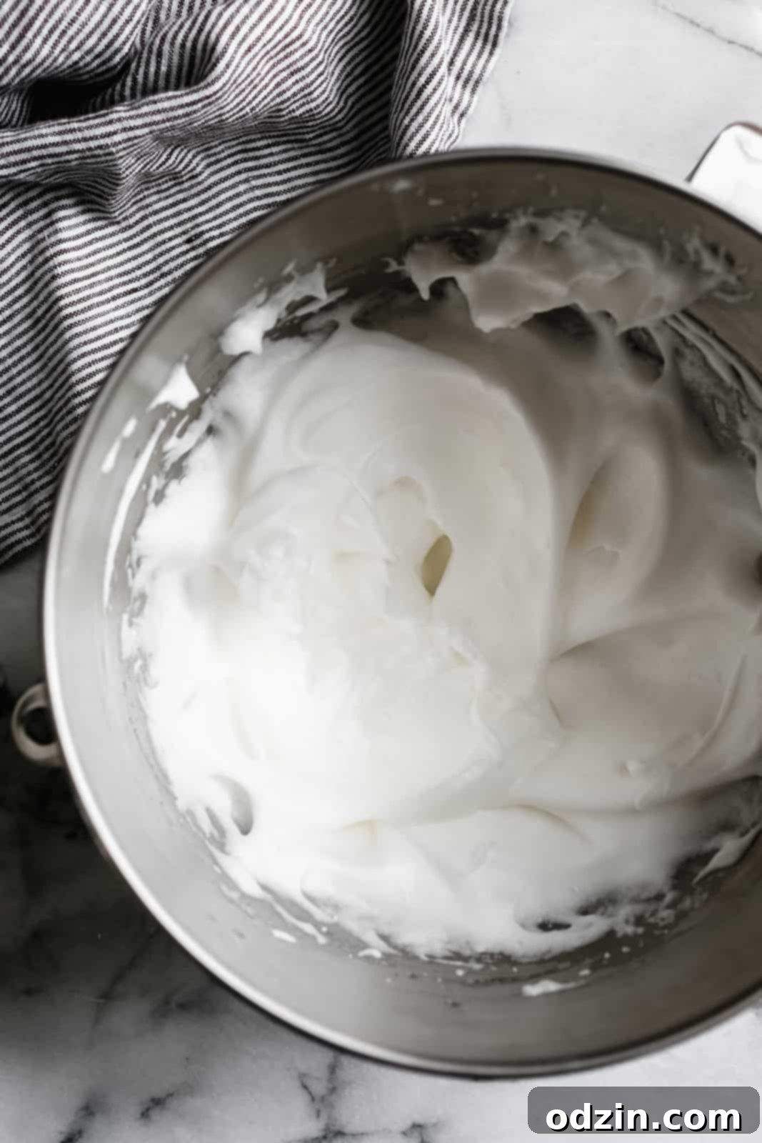 Caprese Flourless Chocolate Cake 5 stand mixer bowl with whipped egg whites so they're white and fluffy