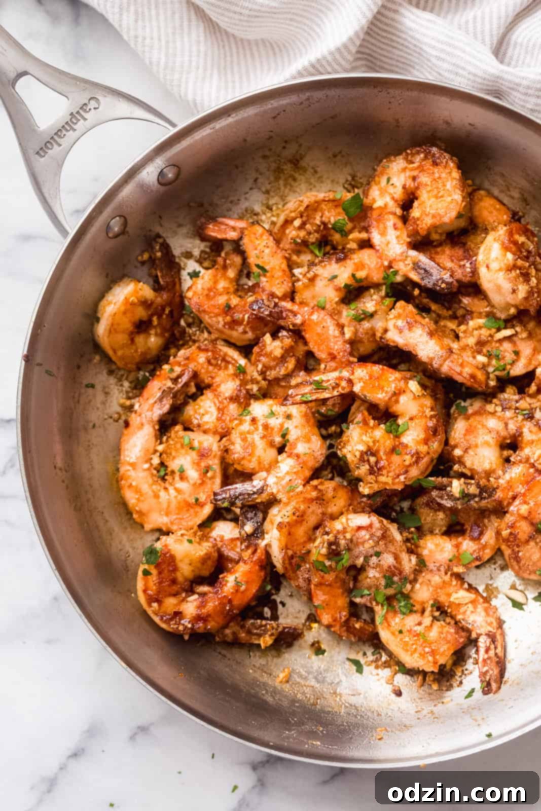 Skillet filled with garlic butter tossed shrimp, ready to be served