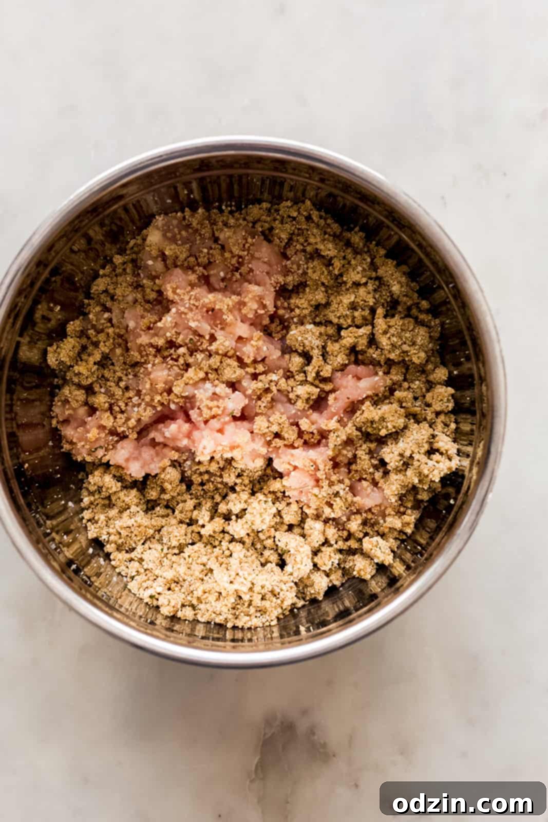 Sticky Honey Chipotle Slow Cooker Meatballs 4 mixing the ground chicken with breadcrumbs to make meatballs in metal bowl
