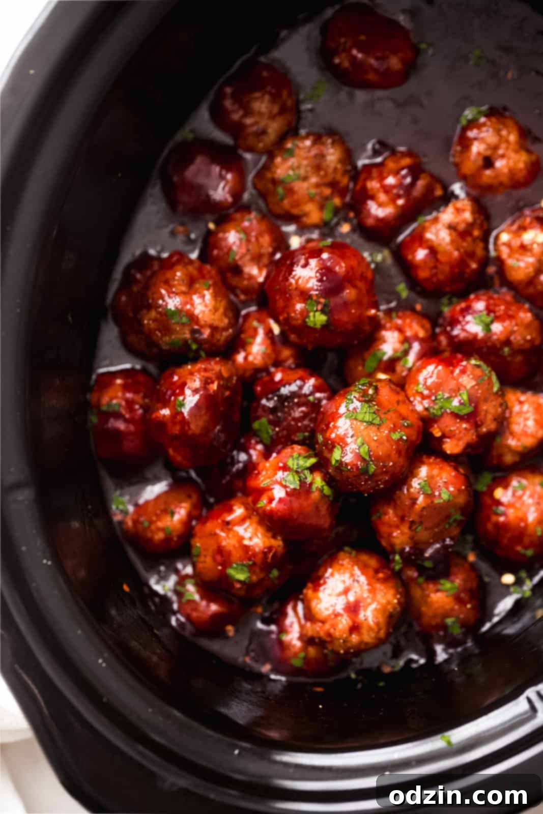 Sticky Honey Chipotle Slow Cooker Meatballs 6 slow cooker with sauce and chicken meatballs topped with parsley