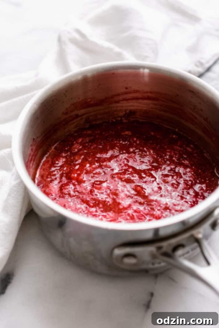 strawberry chia seeds jam in sauce pot on white marble