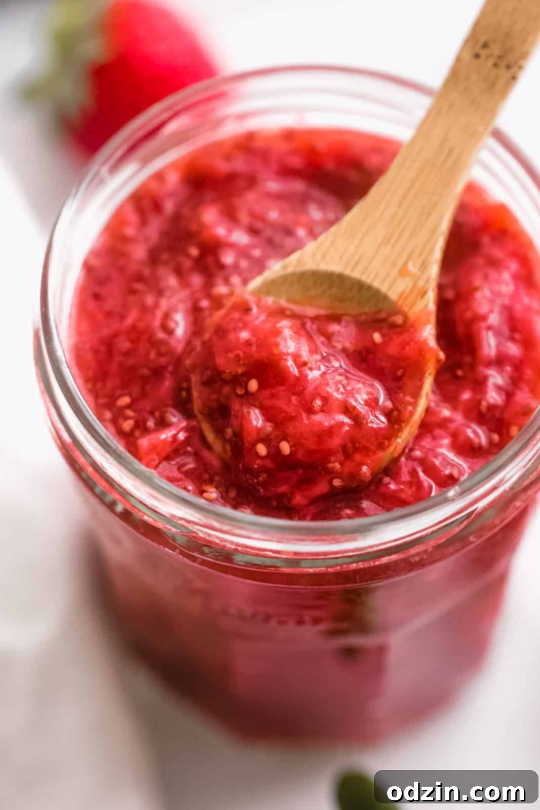 chia seed jam in jar with a spoon resting on the top