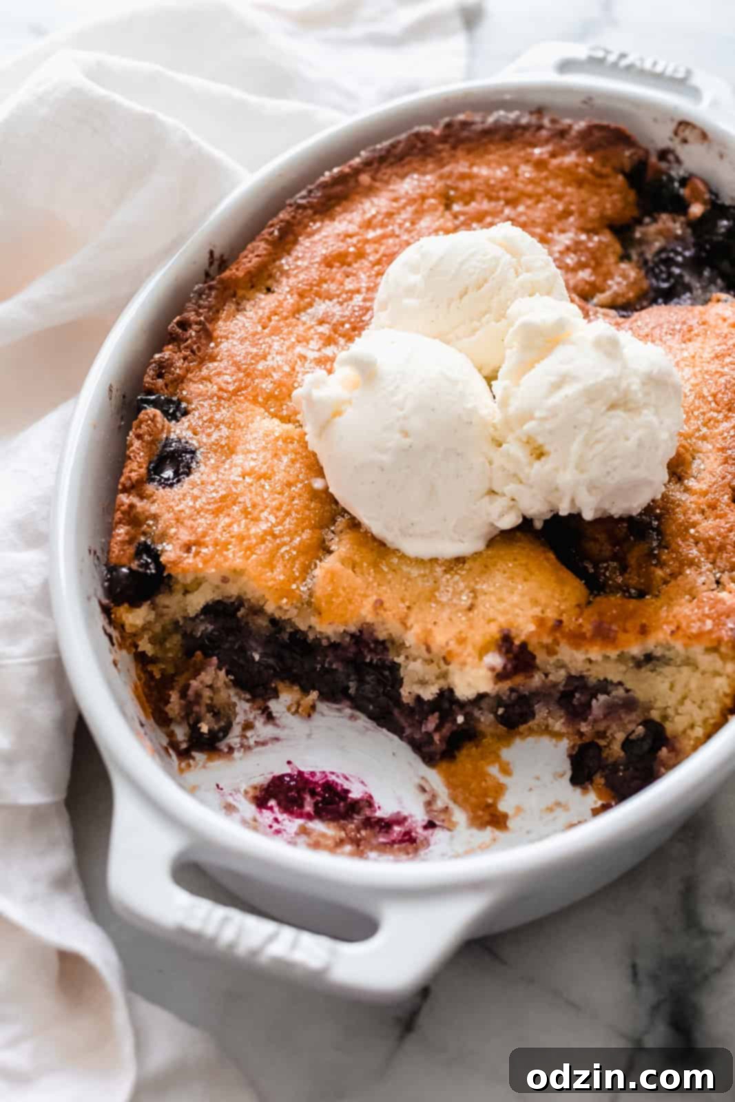 Effortless Texas Blueberry Cobbler 3 side shot showing texture of cobbler topped with vanilla icing