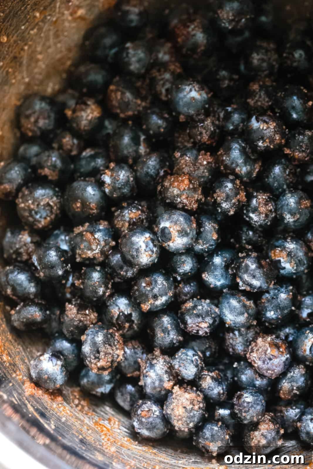 Effortless Texas Blueberry Cobbler 4 stainless steel bowl with blueberries tossed in sugar and cinnamon mixture