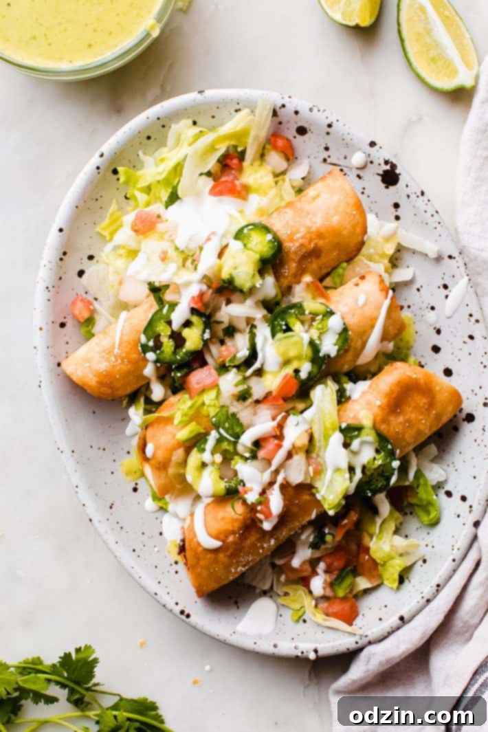 cheesy taquitos with sour cream and toppings