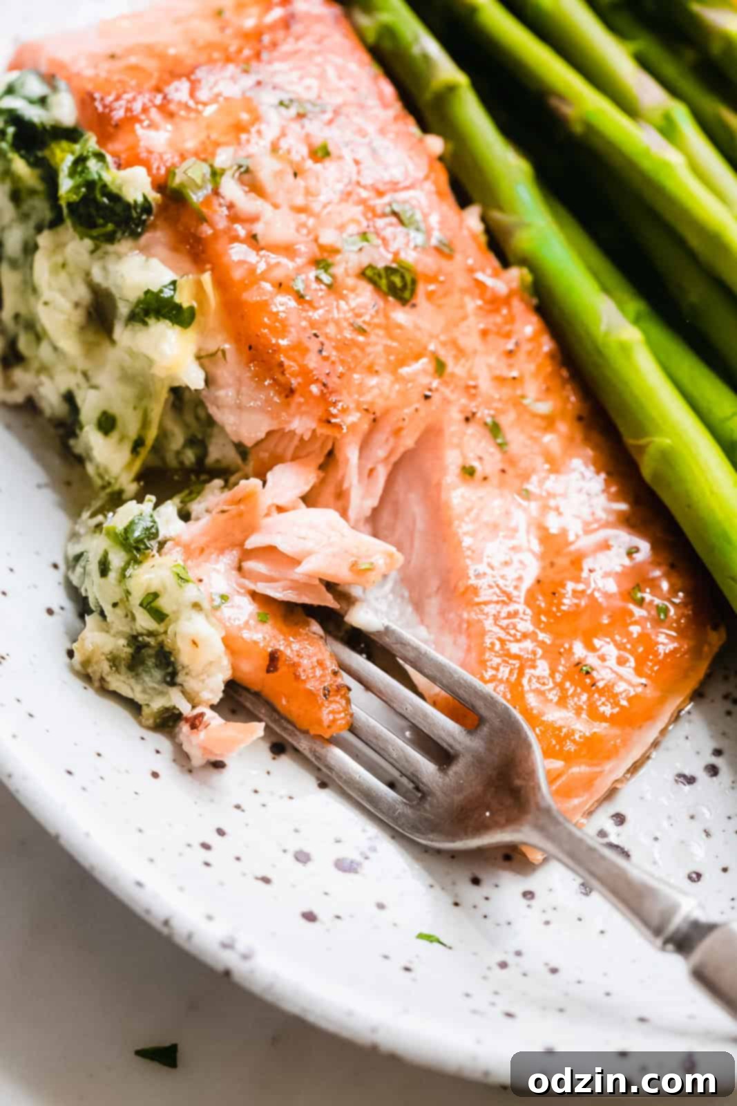 stuffed salmon filet being flaked with a fork