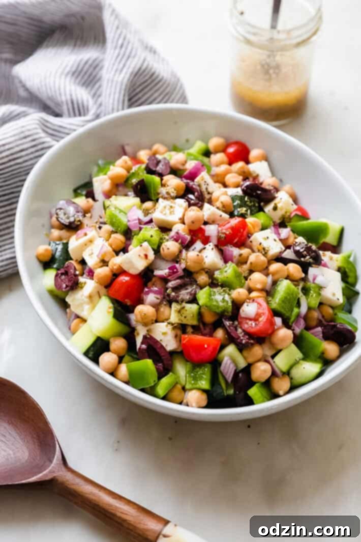 Hellenic Marinated Feta Salad 3 side shot of prepared marinated feta salad in bowl on white marble surface