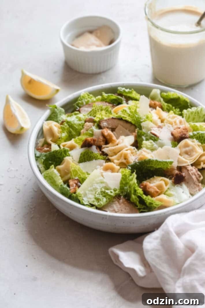 Close-up of Creamy Chicken Tortellini Caesar Salad components: grilled chicken, tortellini, romaine
