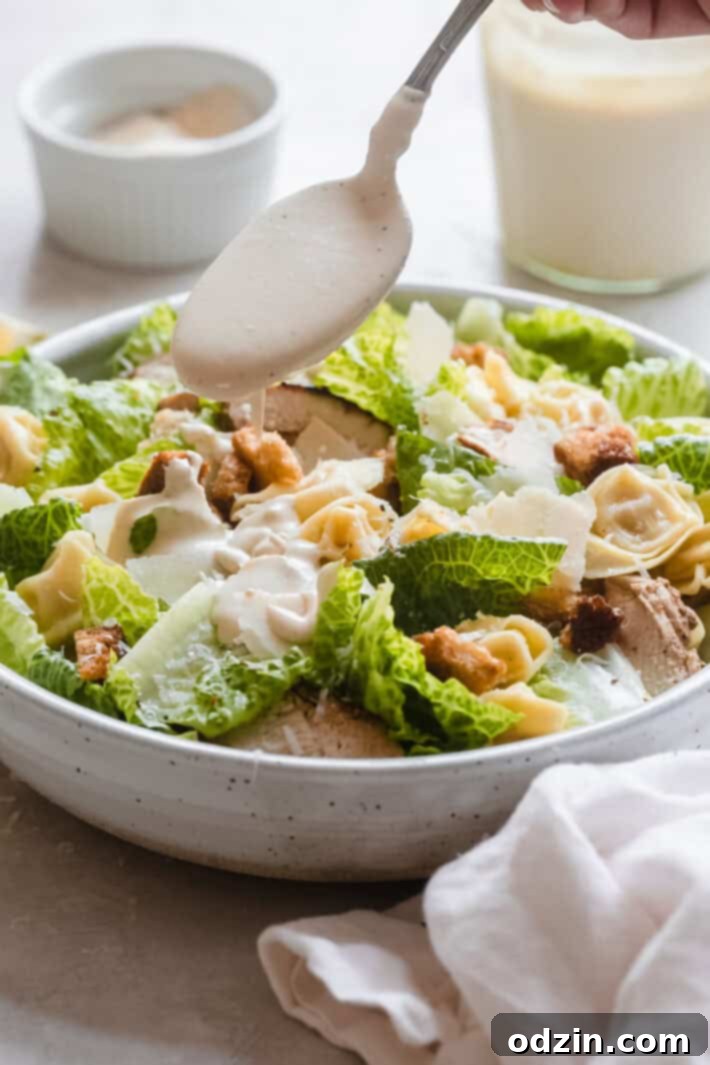 Appetizing close-up of a bowl of Tortellini Caesar Salad, showcasing fresh ingredients