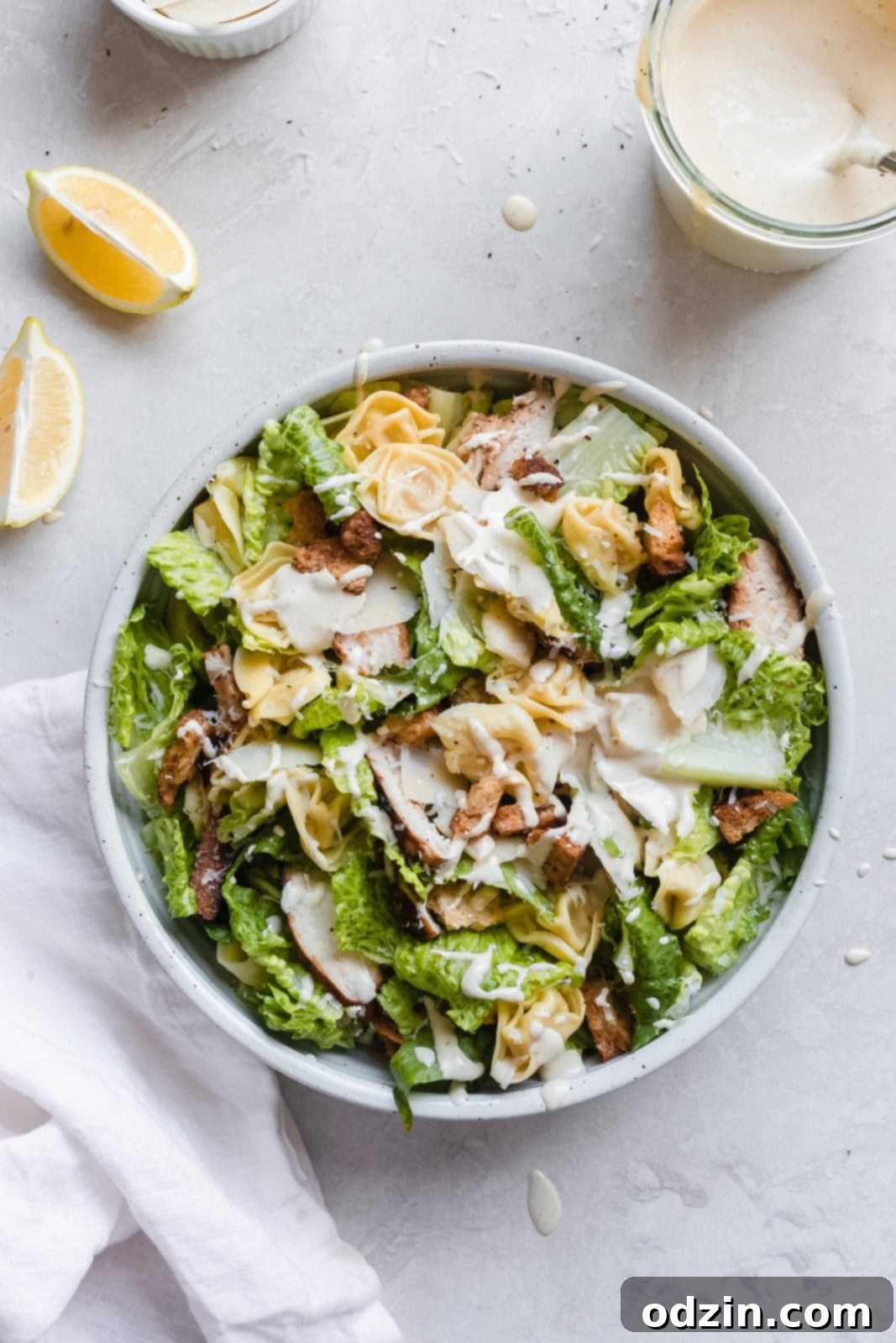 Prepared Tortellini Caesar Salad in a white bowl, ready to serve
