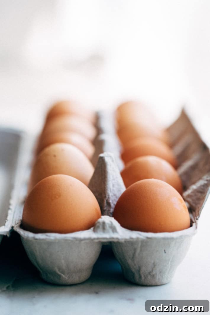 A carton of fresh eggs, ready for preparing into soft-boiled perfection for the salad.