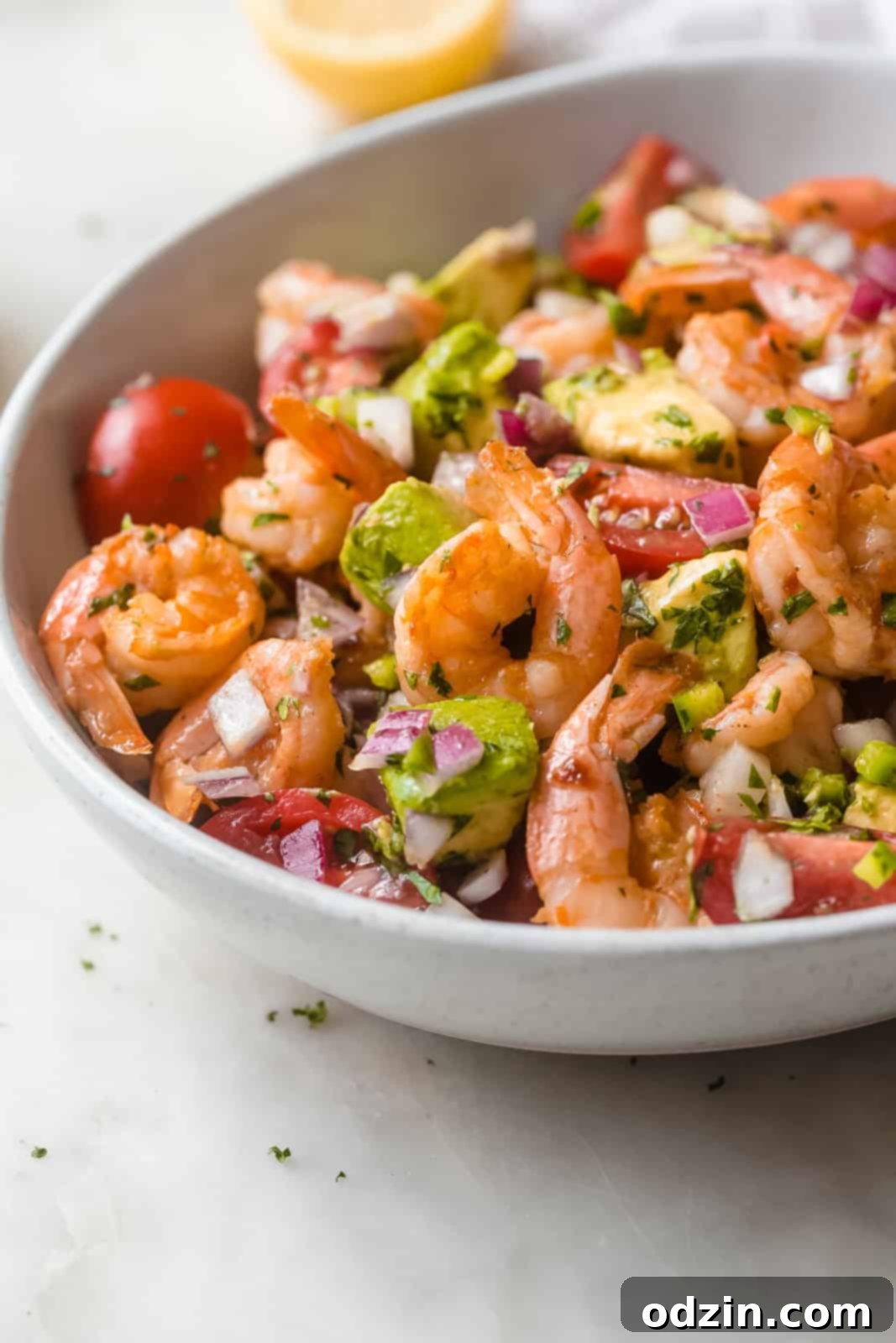 fresh and vibrant shrimp salad with avocados, elegantly dressed with a light lemon cumin dressing