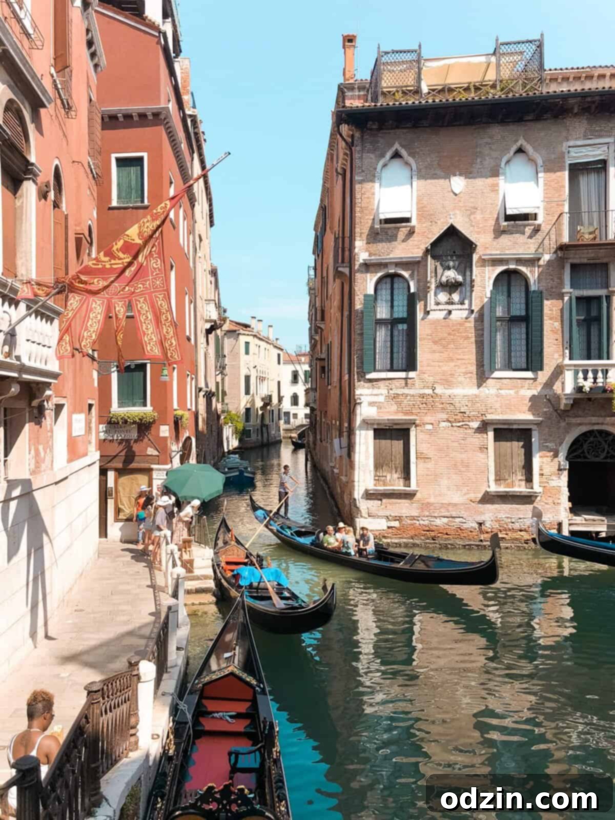 picture of large gondolas about to go through a small canal