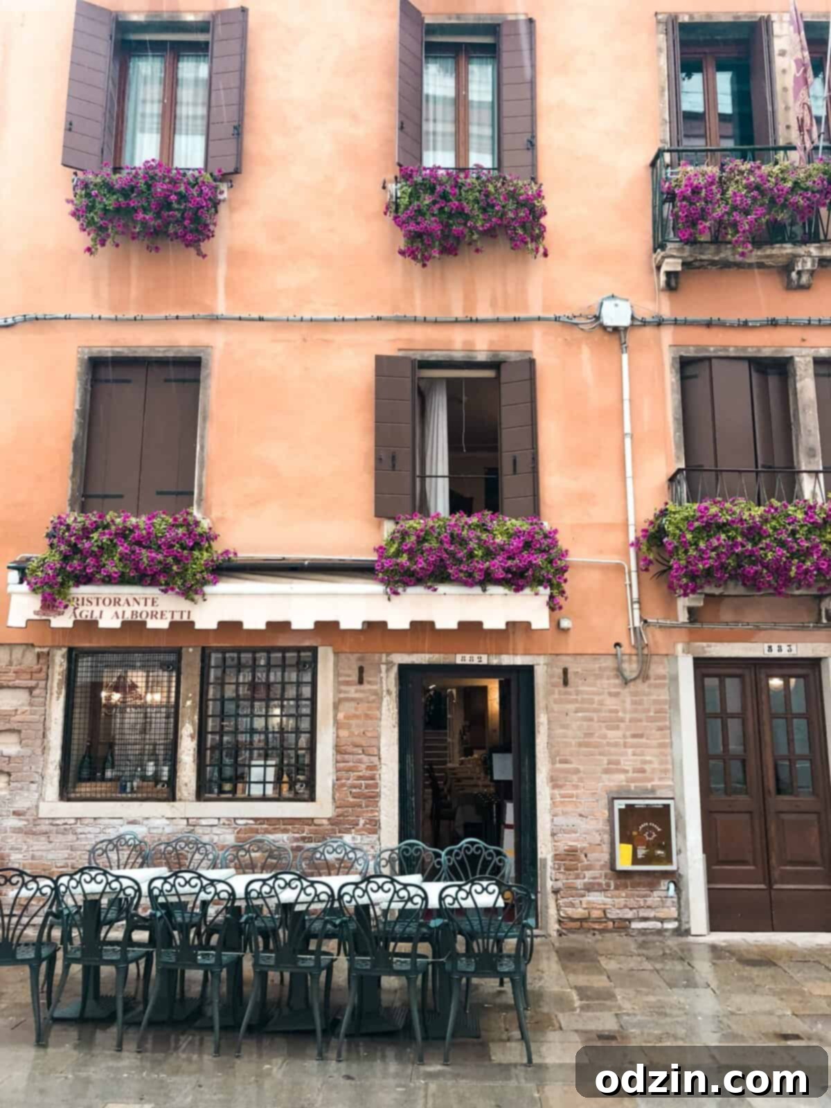 beautiful flowers in the balcony windows on an orange building 