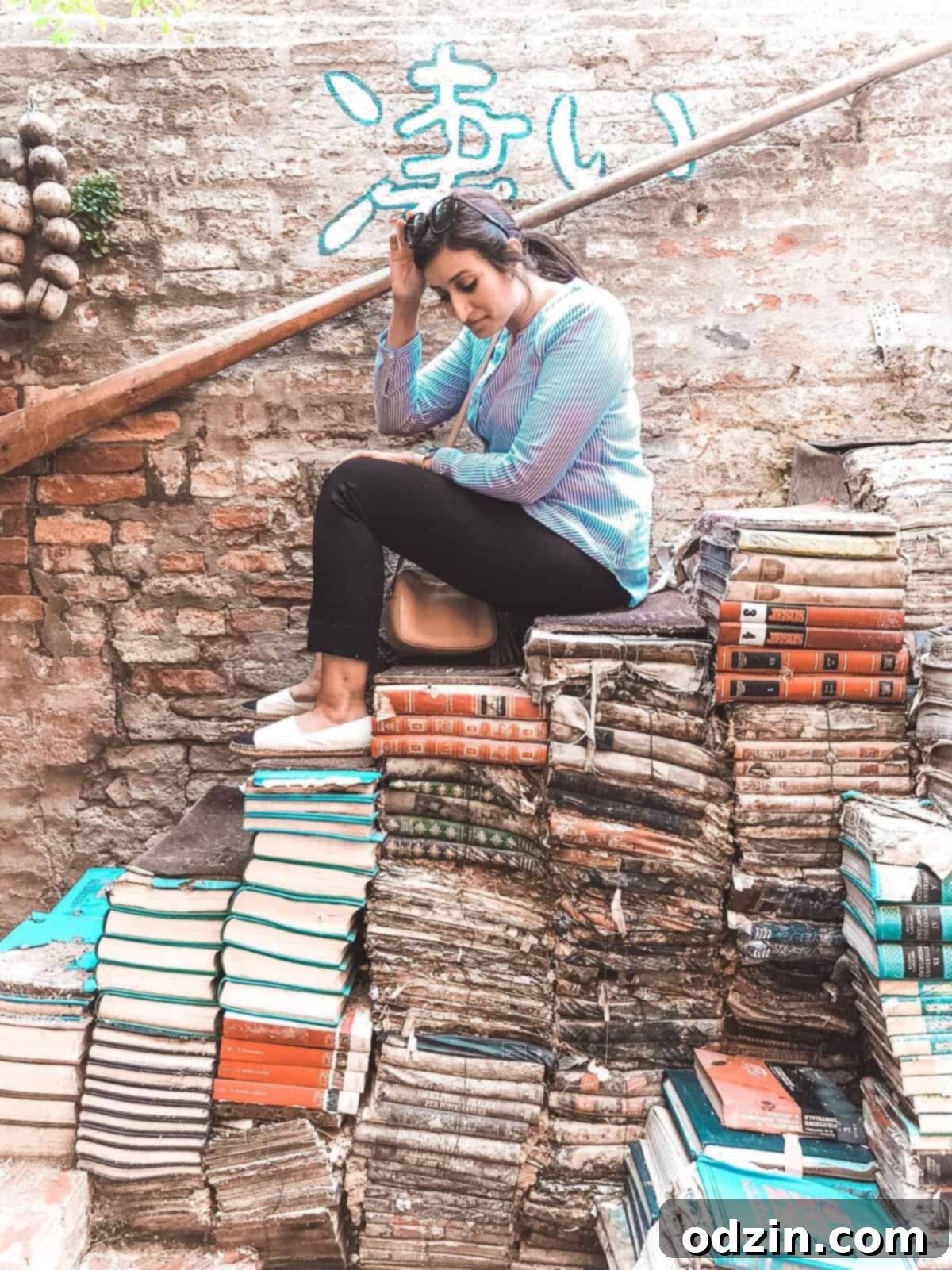 me sitting on a stairway of books in a bookstore on Venice
