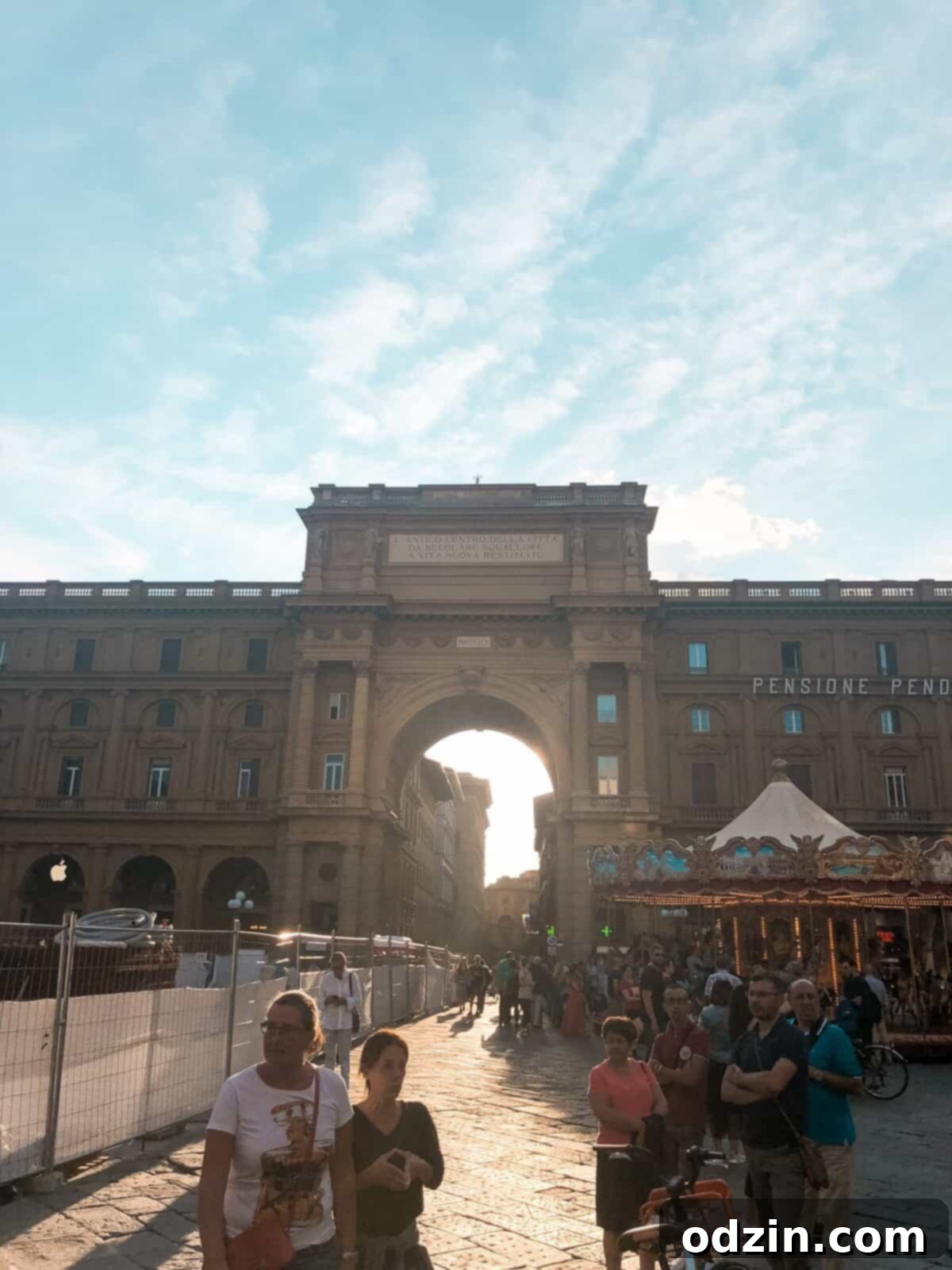 florence at sunset with the sun setting behind a large building
