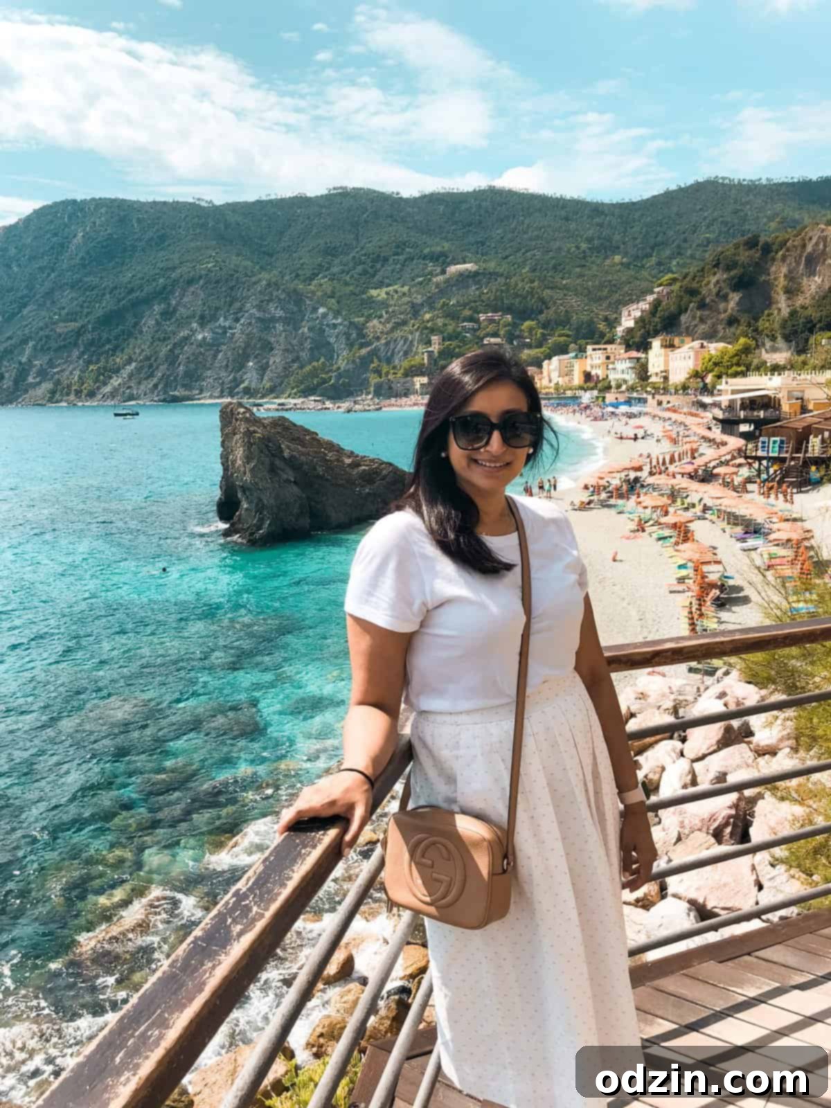 me standing with the aqua water of Monterosso al Mar behind me 