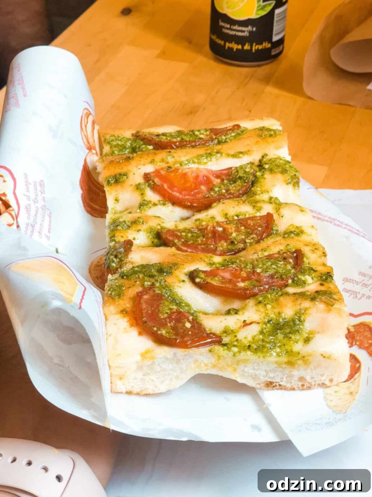 focaccia with slices of tomatoes and basil pesto