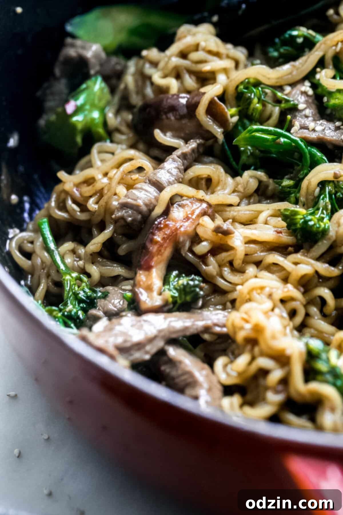 close up of sautéed beef ramen with broccolini and mushrooms